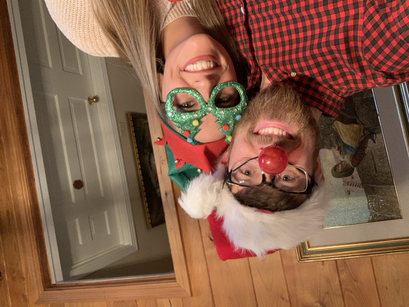 Colton in a Santa hat and red nose with Aly in elf glasses, Christmas 2019